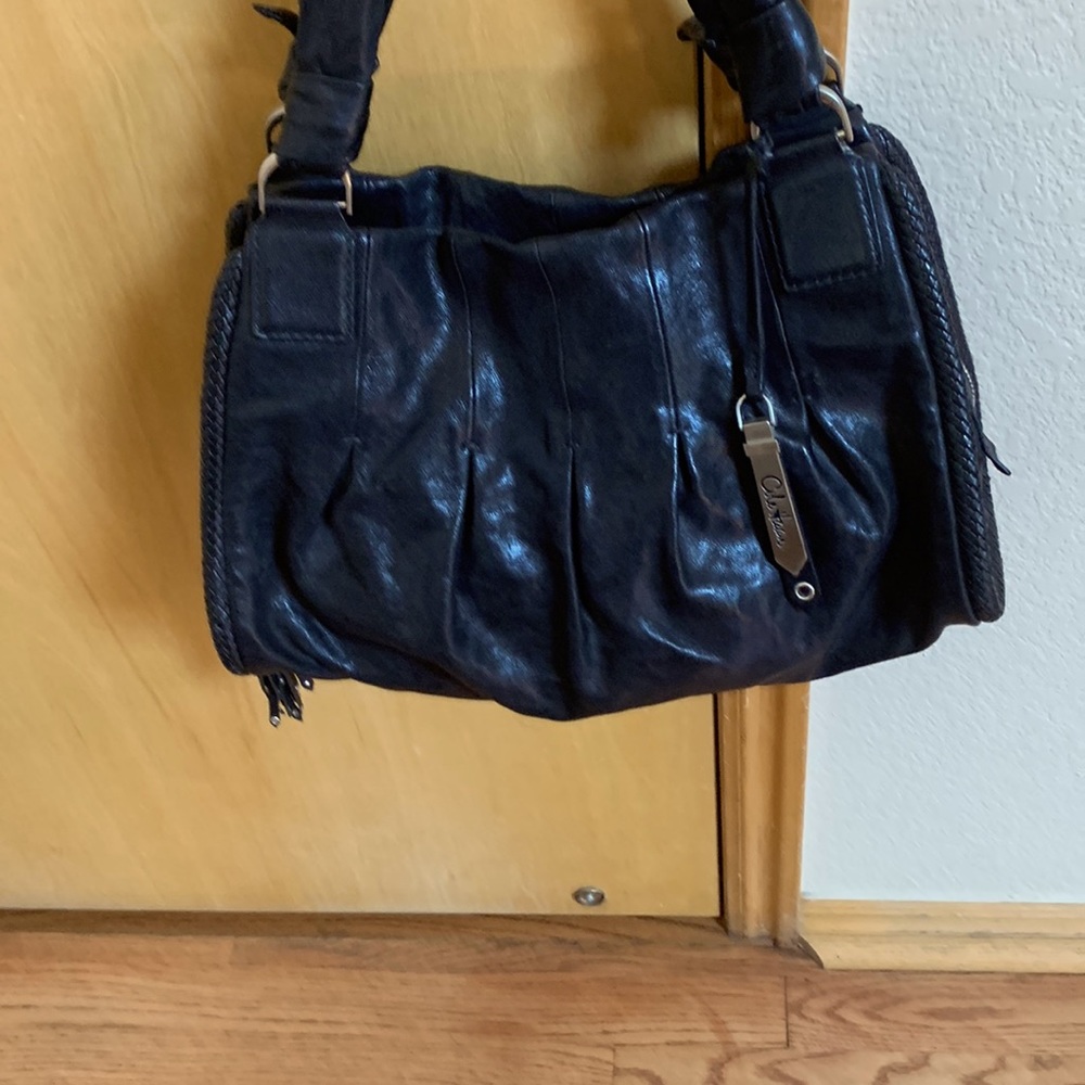 Black leather satchel  with 4 zipped compartments.